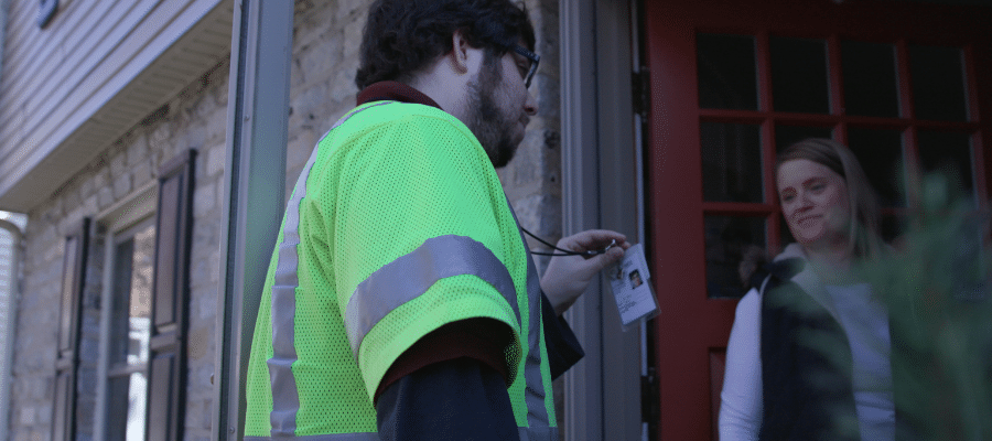 Utility field service professional speaking with a customer during a service visit.